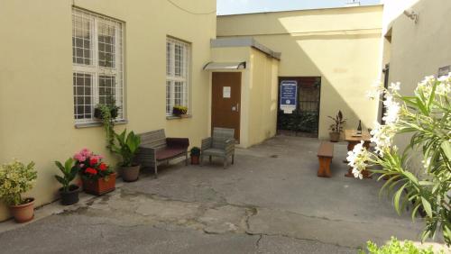 a courtyard of a building with benches and flowers at Penzion U Hradeb in Znojmo