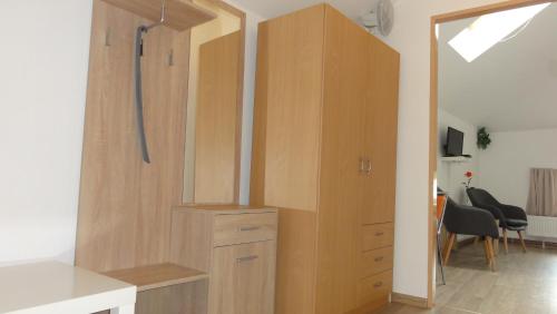a large wooden cabinet in a room at Penzion U Hradeb in Znojmo
