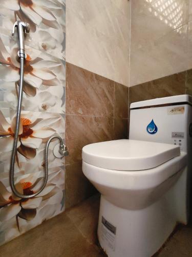 a bathroom with a toilet and a shower at Shova's Home Stay in Kathmandu