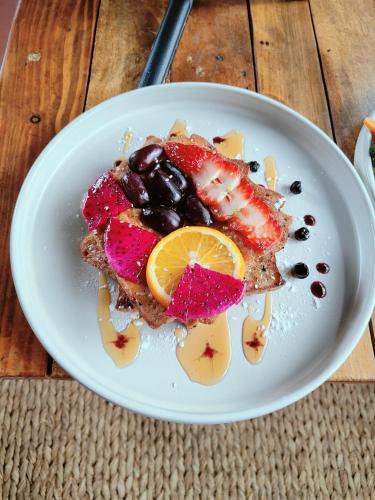 a plate of food with fruit on a table at Shova's Home Stay in Kathmandu
