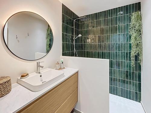 a bathroom with a sink and a mirror at Azur in Cagnes-sur-Mer