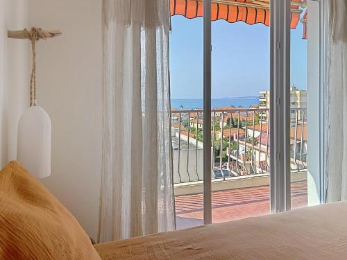 a bedroom with a large window with a view of the ocean at Azur in Cagnes-sur-Mer