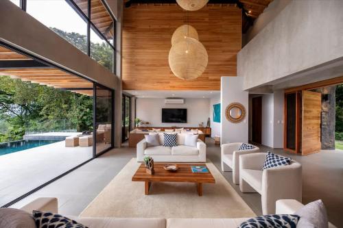a living room with a couch and a table at Villa Kañik - Luxury Retreat with Concierge Services in Dominical