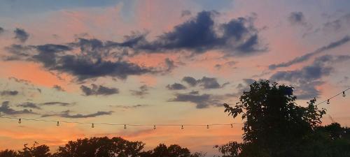 a sunset with birds sitting on a wire at Penzion Recall in Troskovice