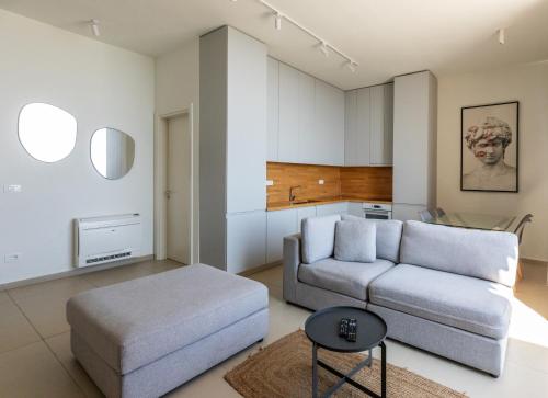 a living room with a couch and a table at Heaven Residence - Green Coast Resort, Palasë in Llogara