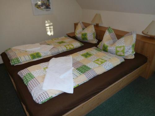 two beds sitting next to each other in a room at Haus am See in Litschau