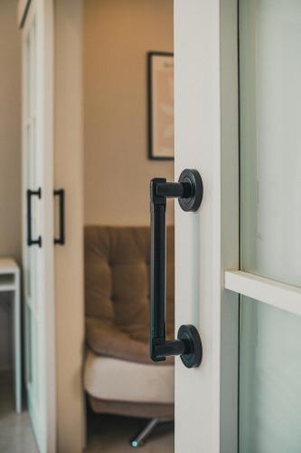a doorhandle of a door with a couch in a room at Jasmin 6 in Alanya