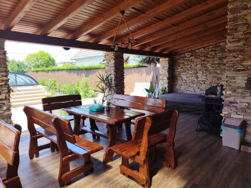 a wooden table and chairs on a patio at PRÉMIUM APARTMANOK in Kisvárda