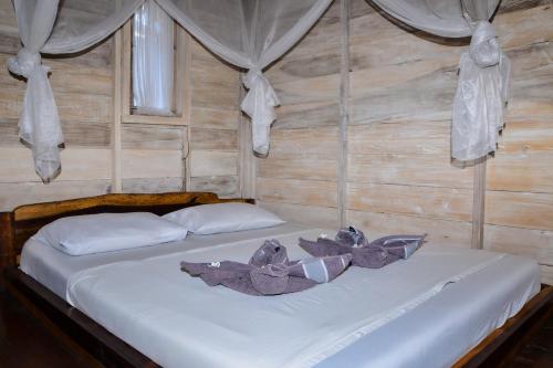 Katil atau katil-katil dalam bilik di Beranda Ecolodge