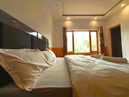 Ένα ή περισσότερα κρεβάτια σε δωμάτιο στο Royal Nangso Guest House