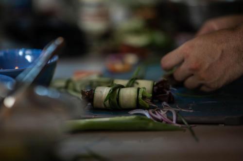 a person is cutting up vegetables on a table at Villa Kañik - Luxury Retreat with Concierge Services in Dominical