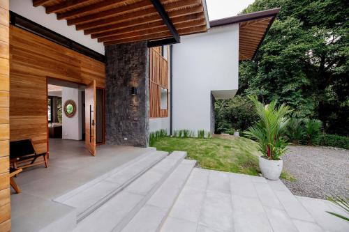 an external view of a house with a patio at Villa Kañik - Luxury Retreat with Concierge Services in Dominical