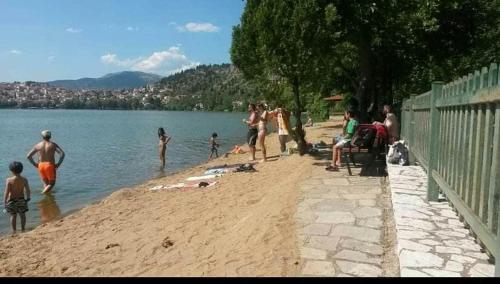 a group of people on a beach near the water at KASTORIA DENDROCHORI Retreat & Rest in Dhendrokhórion