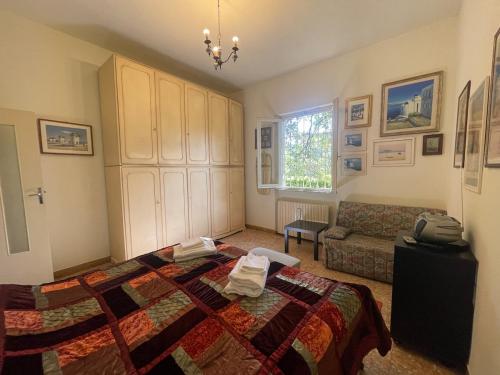 a bedroom with a bed and a couch at Villetta delle Acacie in Pisa