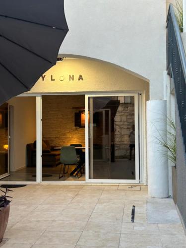 a building with an awning that says loni at Apartments Ylona in Primošten