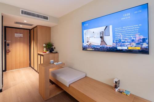 a room with a large screen on the wall at Beijing Tangfu Nanluoguxiang Tian an Men Lama Temple San Li Tun Snack Street Hotel,Free Laundry Dry Service and Free Afternoon Tea &professional Free Tour Ticket Service with English Speaking Staff in Beijing