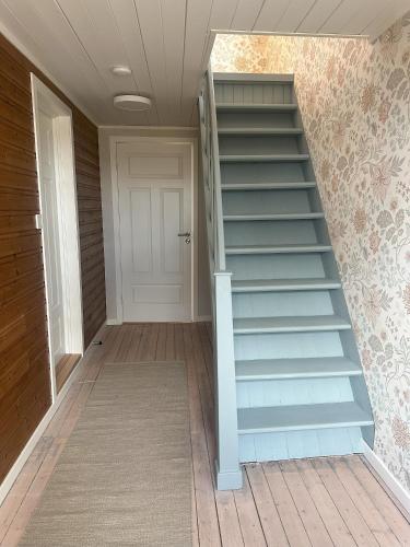 a staircase in a house with a white door at Villa Mårsund in Bø