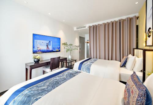 a hotel room with two beds and a flat screen tv at Beijing Tangfu Nanluoguxiang Tian an Men Lama Temple San Li Tun Snack Street Hotel,Free Laundry Dry Service and Free Afternoon Tea &professional Free Tour Ticket Service with English Speaking Staff in Beijing