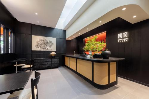 a bar in a restaurant with black walls at Beijing Tangfu Nanluoguxiang Tian an Men Lama Temple San Li Tun Snack Street Hotel,Free Laundry Dry Service and Free Afternoon Tea &professional Free Tour Ticket Service with English Speaking Staff in Beijing