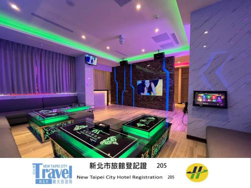 a living room with a table and a tv at Purple Rainbow Motel in Taipei