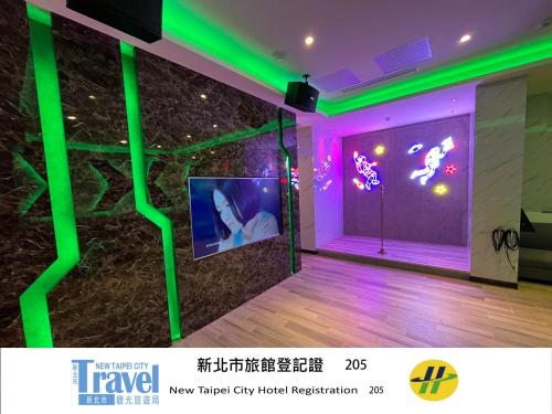 a room with neon lights and a wall with a video screen at Purple Rainbow Motel in Taipei