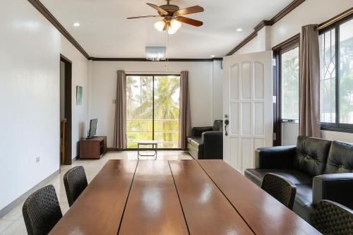 a living room with a table and a couch at Yayay Siargao in General Luna