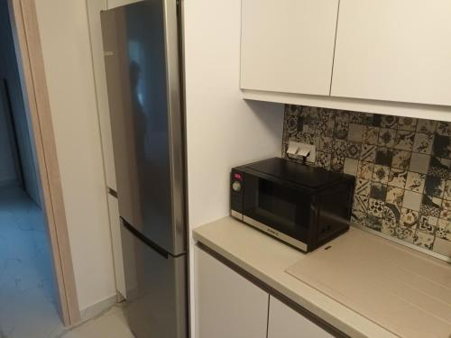 a microwave oven sitting on a counter in a kitchen at Twins house pool 2 in Nikiti