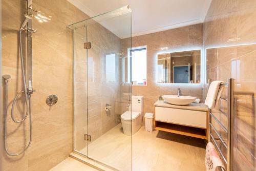 a bathroom with a shower and a sink and a toilet at Supernova B -2 Bedrooms in Lake Tekapo