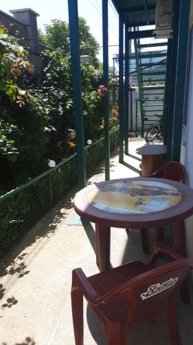 a table and two chairs next to a patio at Solmaris in Odesa