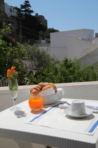 a table with a plate of food and a glass of orange juice at Hotel Degli Ulivi in Castro di Lecce