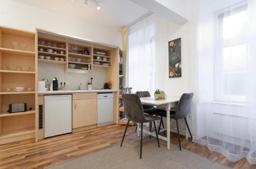 a kitchen and dining room with a table and chairs at Maisonette Gigi in Vienna