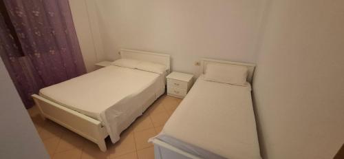 two beds in a small room at Villa Margot in Ksamil