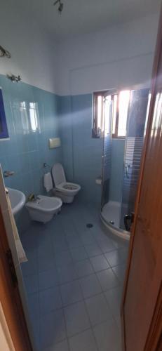 a bathroom with two toilets and a sink and a shower at Villa Margot in Ksamil