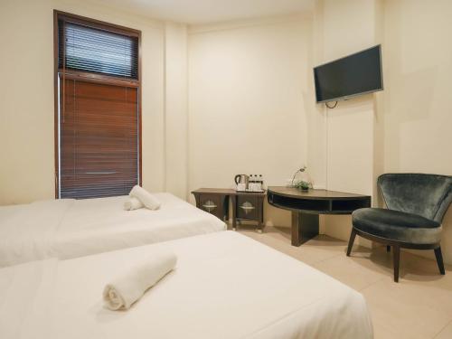 Ένα ή περισσότερα κρεβάτια σε δωμάτιο στο Asphodel Inn