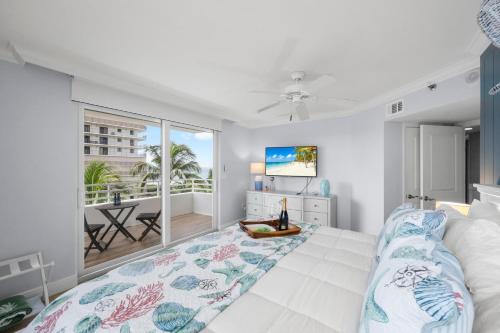 a bedroom with a bed and a large window at Somerset three-bedroom end unit beachfront condo in Marco Island