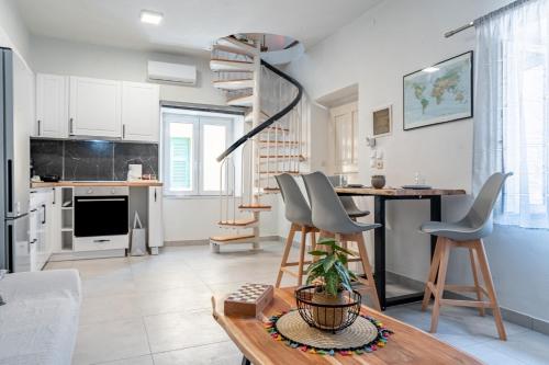 a kitchen and living room with a spiral stair at Casa Di Babis in Gaios