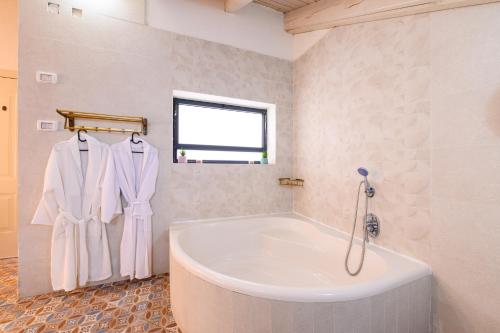 a bathroom with a large tub and a window at הזהר הצפוני in Rosh Pinna