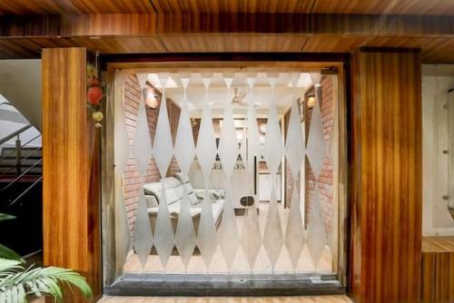 a glass door of a room with a white fence at Hotel JD in Surat