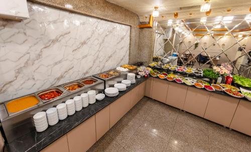 a buffet line with food in a restaurant at Hamit Hotel Istanbul in Istanbul