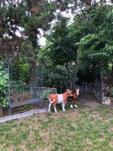a brown and white dog standing in front of a gate at Apartmány na náměstí - Kounice in Kounice