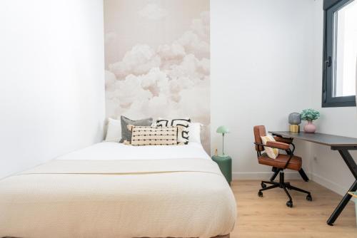 a bedroom with a bed and a desk at Live It Malaga in Málaga