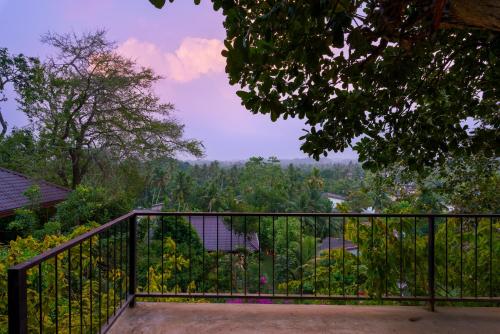 a balcony with a view of a forest at Villa Rumassala Luxury Chalets Unawatuna in Unawatuna