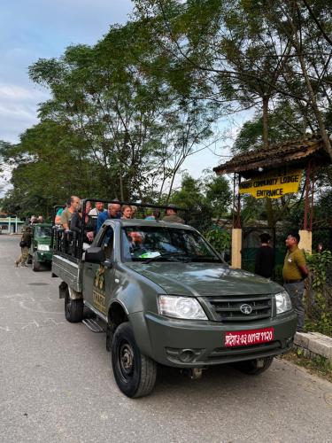a group of people riding in the back of a pick up truck at Tharu Community Lodge in Kawasoti