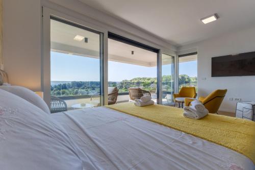 a bedroom with a large bed with a large window at Casagrande in Krk