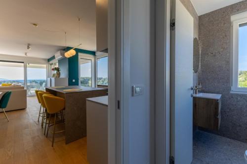 a kitchen and living room with a view of the ocean at Casagrande in Krk