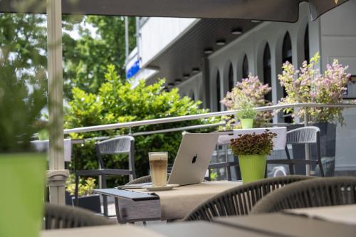 an outdoor table with a laptop computer on top of it at Maritim Hotel Darmstadt in Darmstadt