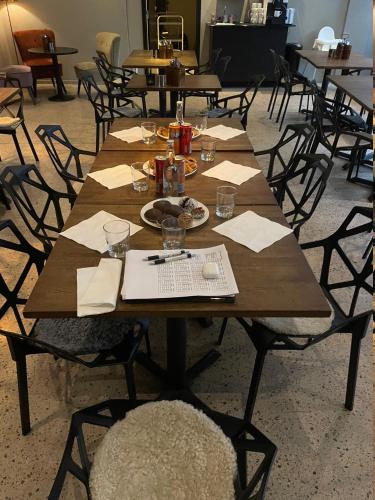 a wooden table with a plate of food on it at Lidingö Arena Hotel in Lidingö