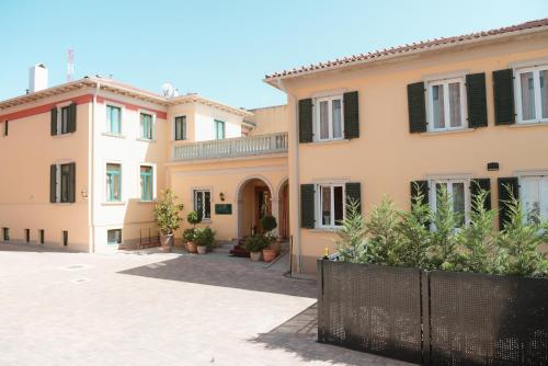 a row of houses with a fence in front of them at Hotel La Residenza in Timişoara