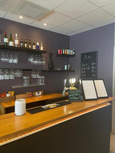a bar with a counter with wine glasses at Lidingö Arena Hotel in Lidingö