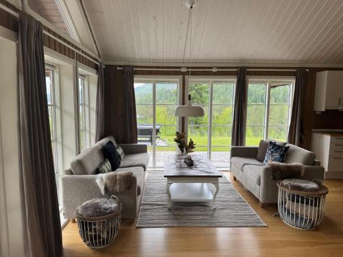 a living room with two couches and a table at Nystul Panorama in Lona